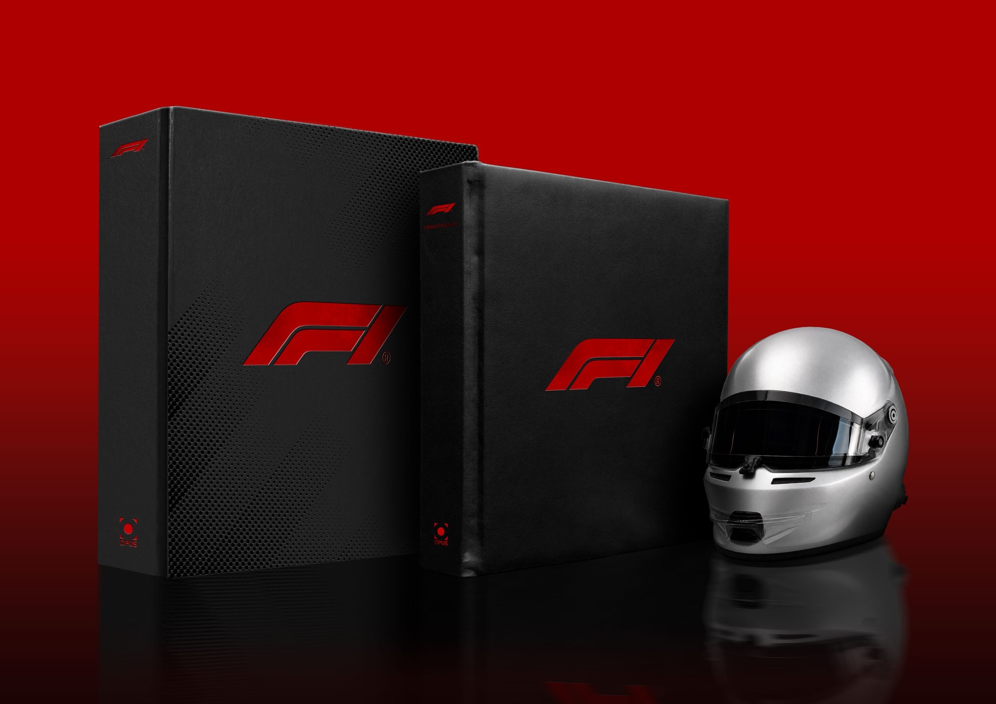 The Official F1 75 Opus presentation case alongside a racing helmet